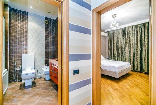 a bedroom with a bed and a bathroom at 3 Bedrooms Apartment ın Center in Baku