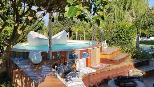 a pool with a hot tub in a backyard at Summer IGLOO by the sea in COCOland in Pálioura