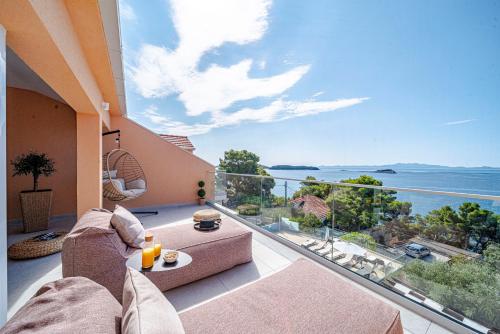 a large balcony with a view of the ocean at Apartments Separovic in Prizba