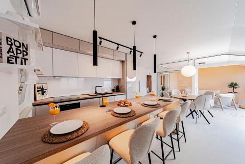 a kitchen and dining room with a long wooden table and chairs at Apartments Separovic in Prizba