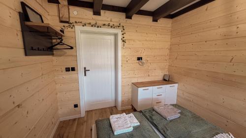 a room with a white door and a wooden wall at Zdrojowe wzgórze in Rymanów-Zdrój