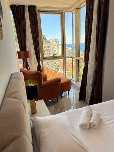 a hotel room with a bed and a large window at Lux Apartment Vidovic II in Rafailovici