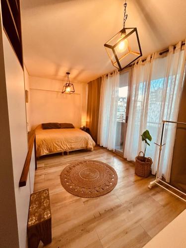 a bedroom with a bed and a large window at Rent Montañeses Nuñez in Buenos Aires
