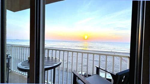 a view of the beach from a balcony at Boardwalk Oceanfront Condo with Panoramic Views in Virginia Beach