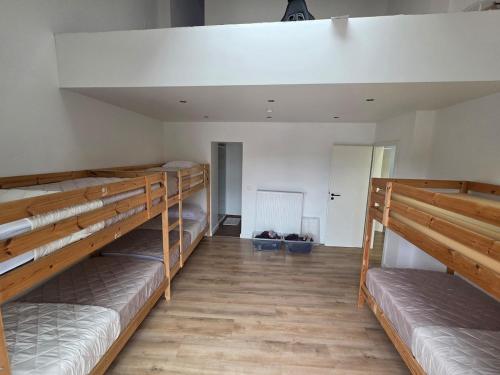 two bunk beds in a room with wooden floors at Home cinema in Liège