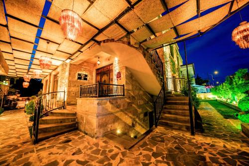 a building with a staircase and chandeliers at Louis Cappadocia in Uçhisar