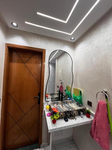 a bathroom with a mirror and a sink at Stoph in Beni Mellal