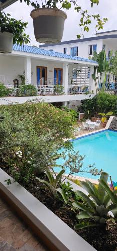 a hotel with a swimming pool in front of a building at Doña Mayra Aparta Hotel in Las Terrenas