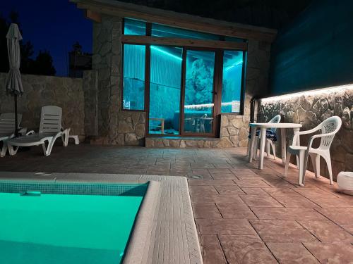 a house with a pool and a table and chairs at Casa Tio Paco in Cazorla
