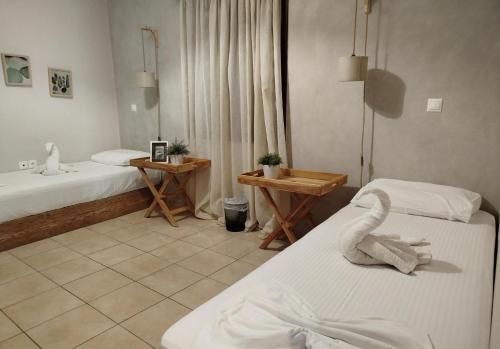 a hotel room with two beds and a bathroom at Casa di Emmanuel in Kalymnos