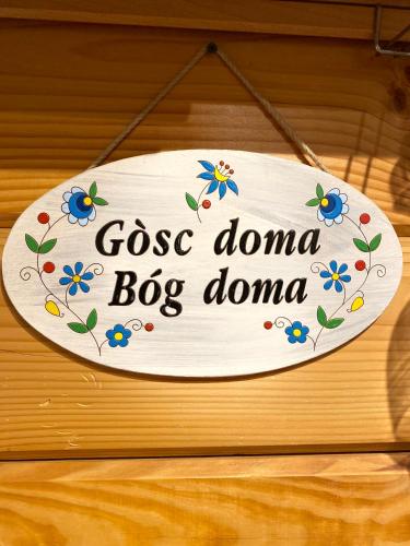 a sign that says goo dana dog domino at Sunny House Baltic in Kopalino