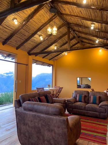 a living room with two couches and a table at Mountain View Lodge & Experience in Cusco
