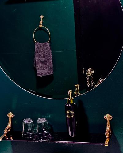 a green bathroom with a mirror and three glasses at Seaside Retreat, Glacier View in Hellissandur