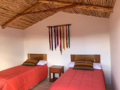 two beds sitting next to each other in a room at Mountain View Lodge & Experience in Cusco