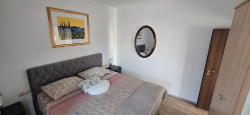 a bedroom with a bed and a mirror on the wall at Pool, Sauna, Jacuzzi with Sea view - Apartment Josipa in Podstrana