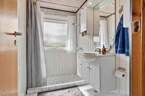 a white bathroom with a shower and a sink at FY348-Svendborg-Storkenaebsvej-1 in Svendborg