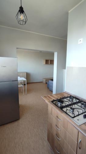 a kitchen with a stove top oven in a room at SkyView Studio Łódź - 11th Floor - Free Parking in Łódź
