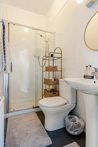 a bathroom with a toilet and a sink and a shower at Edinburgh Beach in Edinburgh