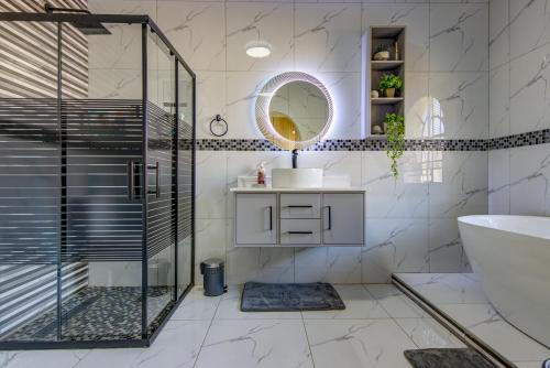 a bathroom with a shower and a sink and a mirror at Kempton kingdom in Kempton Park