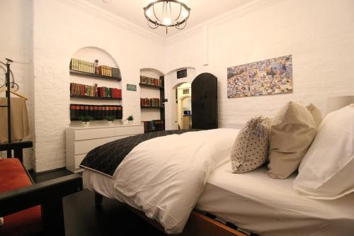 a bedroom with a large white bed in a room at The Ironbridge Lockup - Former Cell in Ironbridge