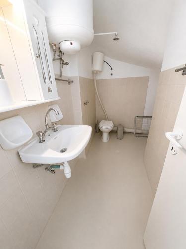 a bathroom with a sink and a toilet at Mani Spot Manani in Pyrgos Dirou