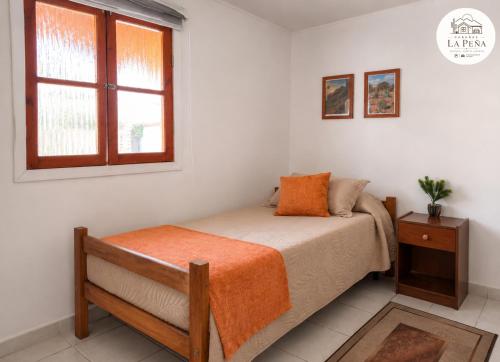 a bedroom with a bed and a window at Cabañas nuevas La Peña in Taltal