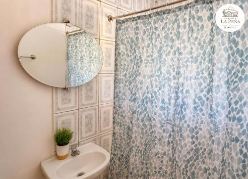 a bathroom with a shower curtain and a sink at Cabañas nuevas La Peña in Taltal