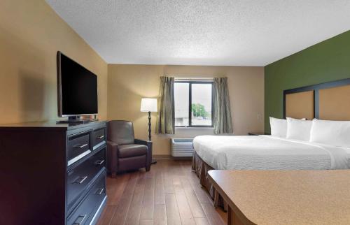 a hotel room with two beds and a flat screen tv at Extended Stay America Suites - Knoxville - West Hills in Knoxville