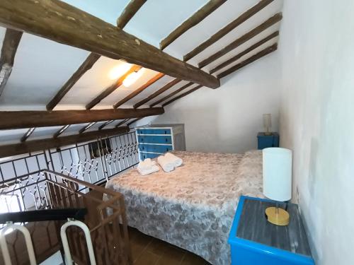 a bedroom with a bed in a room with wooden ceilings at La casetta del masso in Sorano