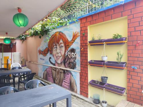 a mural on the side of a restaurant at Villa Villekulla in Tirana