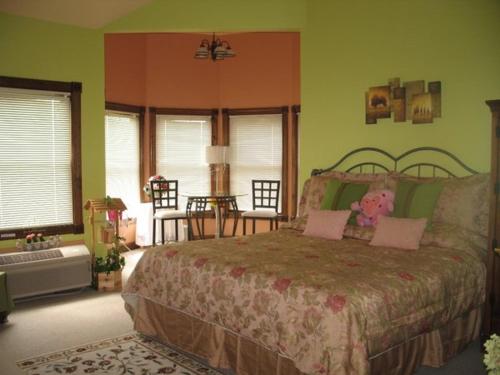 a bedroom with a bed with a teddy bear on it at Spruce Hill Inn & Cottages in Mansfield