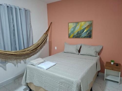 a bedroom with a bed and a window at Pousada Flor de Sal in Macau