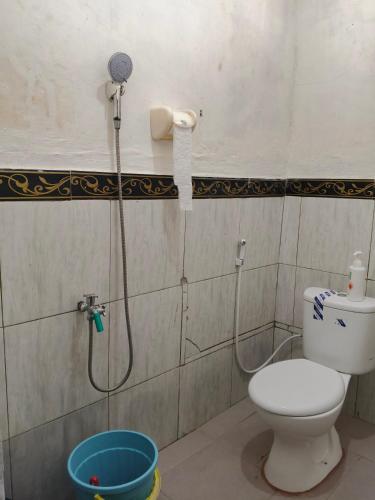 a bathroom with a toilet and a shower at Sherin Homestay in Pulau Sarang