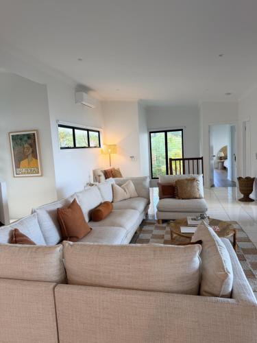a living room with a couch and a table at The Dune House in Tangalooma