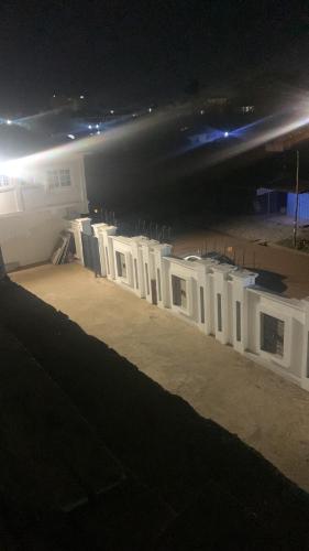 a long row of white barriers in a building at night at Antopom Heights & Suites in Sunyani