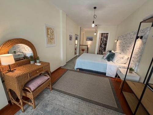 a bedroom with a bed and a desk and a mirror at 11 Diamond Drive, Luxury Bright & Quiet City Center Loft, Easy Access in Kavála