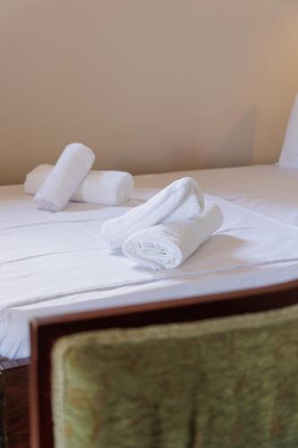 two white towels sitting on top of a bed at Aspalathos guest rooms in Vathia