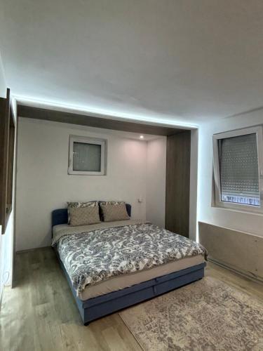 a bedroom with a large bed in a room at Iskra DDUR in Gornji Milanovac