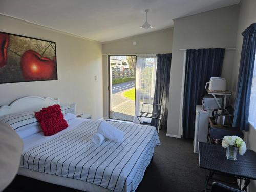 a hotel room with a bed and a window at Quiet Boutique Generous Breakfast in Palmerston North