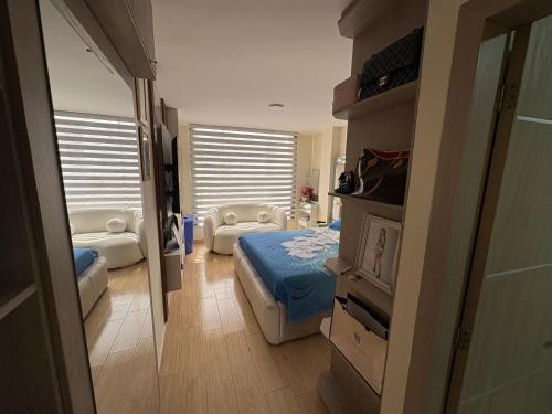 a bedroom with a bed and a chair in it at Alojamiento in Ibarra