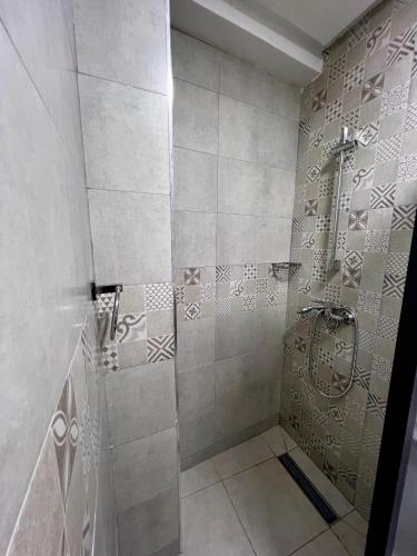 a bathroom with a shower with a glass door at Riad Maison Eden in Rabat