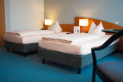 Llit o llits en una habitació de Hotel Stadt Püttlingen