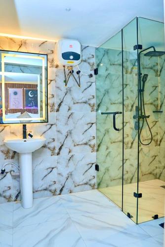 a bathroom with a sink and a shower at Luxembourg Apartment in Lagos