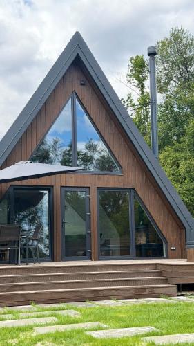 a house with large windows and a roof at Lofty House Mountain Tustan in Urych