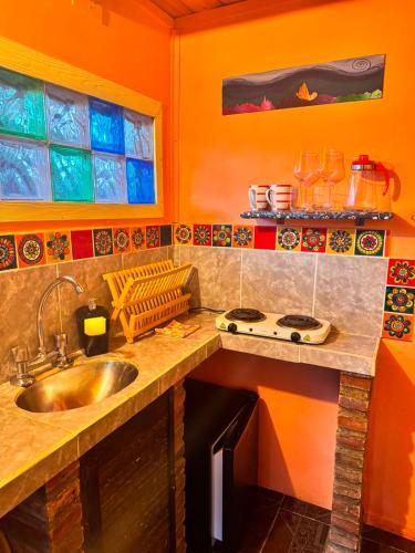 a kitchen with a sink and a counter top at El Kamaruco Tiny House in El Chalten