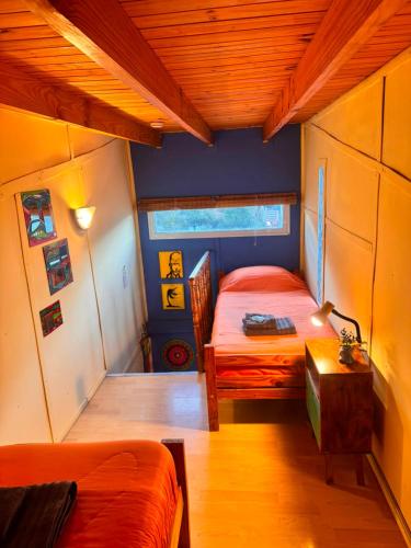 a bedroom with two beds and a table in it at El Kamaruco Tiny House in El Chalten