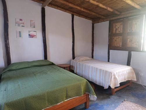 a bedroom with two beds in a room at Guayobungalows in Máncora