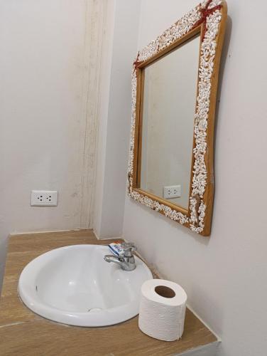a bathroom with a sink and a mirror on the wall at Guayobungalows in Máncora