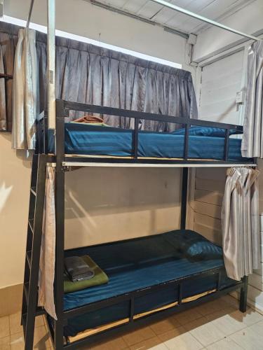 a couple of bunk beds in a room at Pakse Green Adventure Hostel Two in Pakse