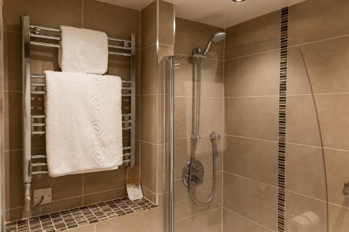 a bathroom with a shower, toilet, and sink at Mercure Newcastle George Washington Hotel Golf & Spa in Newcastle upon Tyne